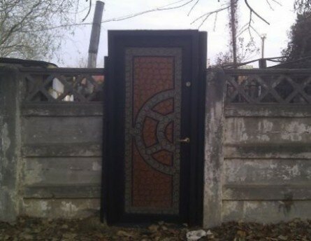 Funny metal door in concrete fence